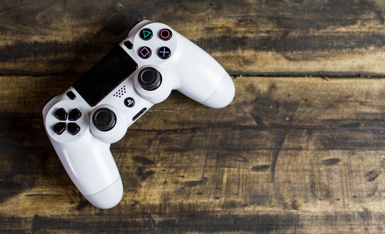 White PS4 controller on a wooden table