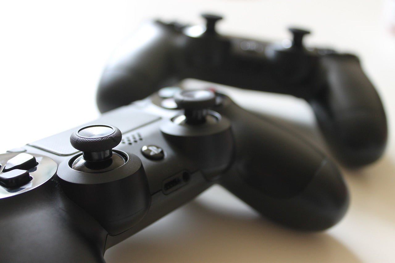 Two black PS4 controllers