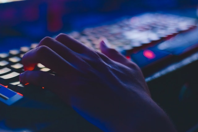 Hand on a backlit gaming keyboard